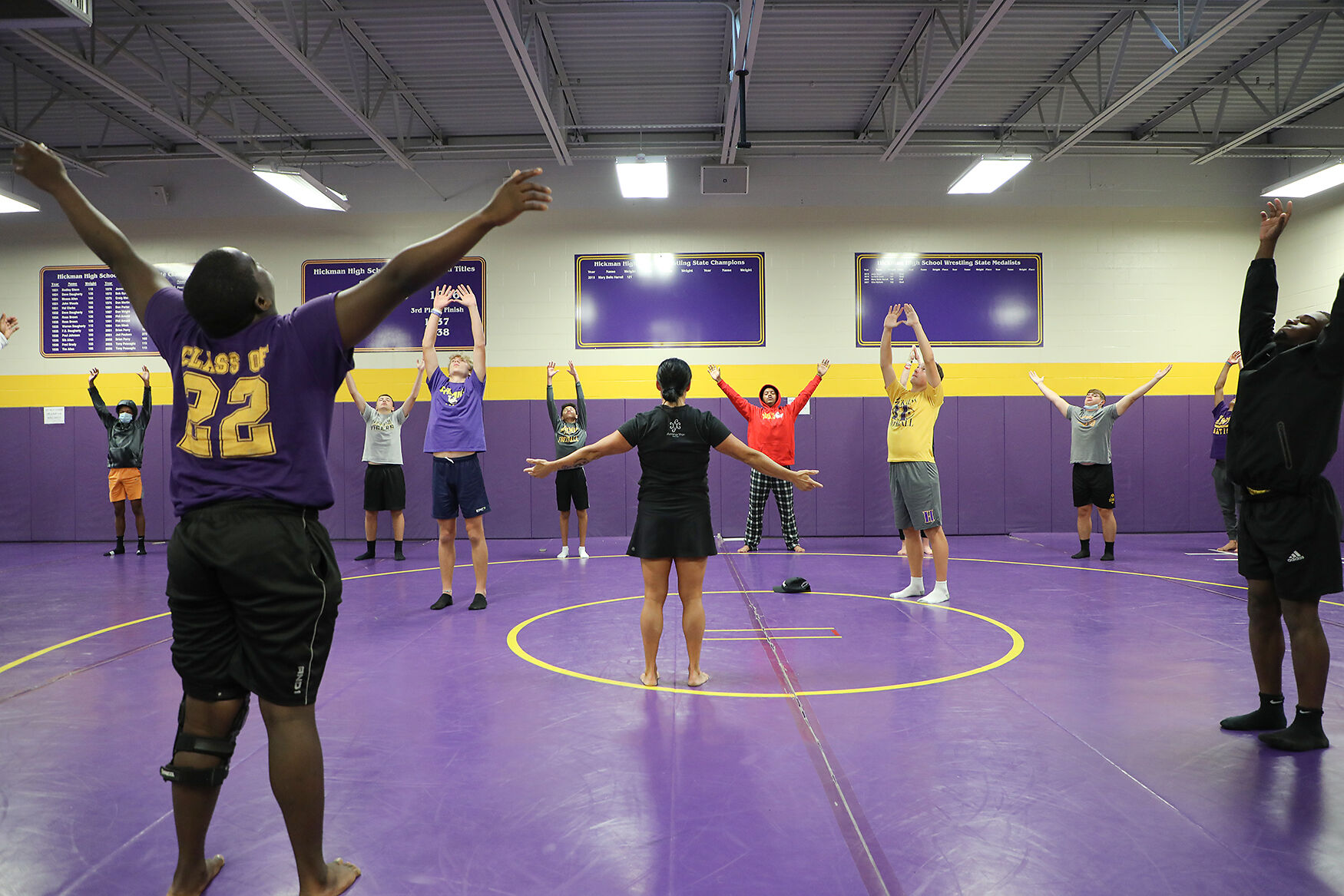 The Hickman high school varsity football team participates in a group yoga